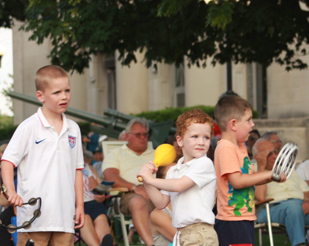 Children play along with the Air National Guard Band of the Midwest as its Airmen perform for audiences during annual training at the Grundy County Courtyard Lawn, Morris, Ill., June 29, 2014. They performed jazz, rock and concert music for audiences in Illinois and Wisconsin as part of their community relations tour before a grand finale in Minnesota July 4. The annual concert series was the result of a year’s worth of training and practice, one that the band used to celebrate patriotism with communities across the Midwest. (Courtesy photo/Released)