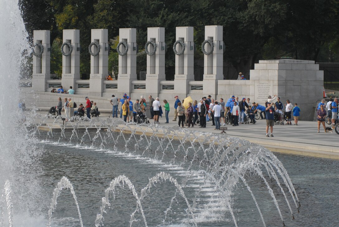 World War II veterans and family members mingle  at the World War II Memorial in Washington, D.C., Sept. 19, 2014. The veterans were part of a group of 66 that were there to see their memorial, many for the first time.(U.S. Air Force photo by Senior Master Sgt. Gary J. Rihn/Released)