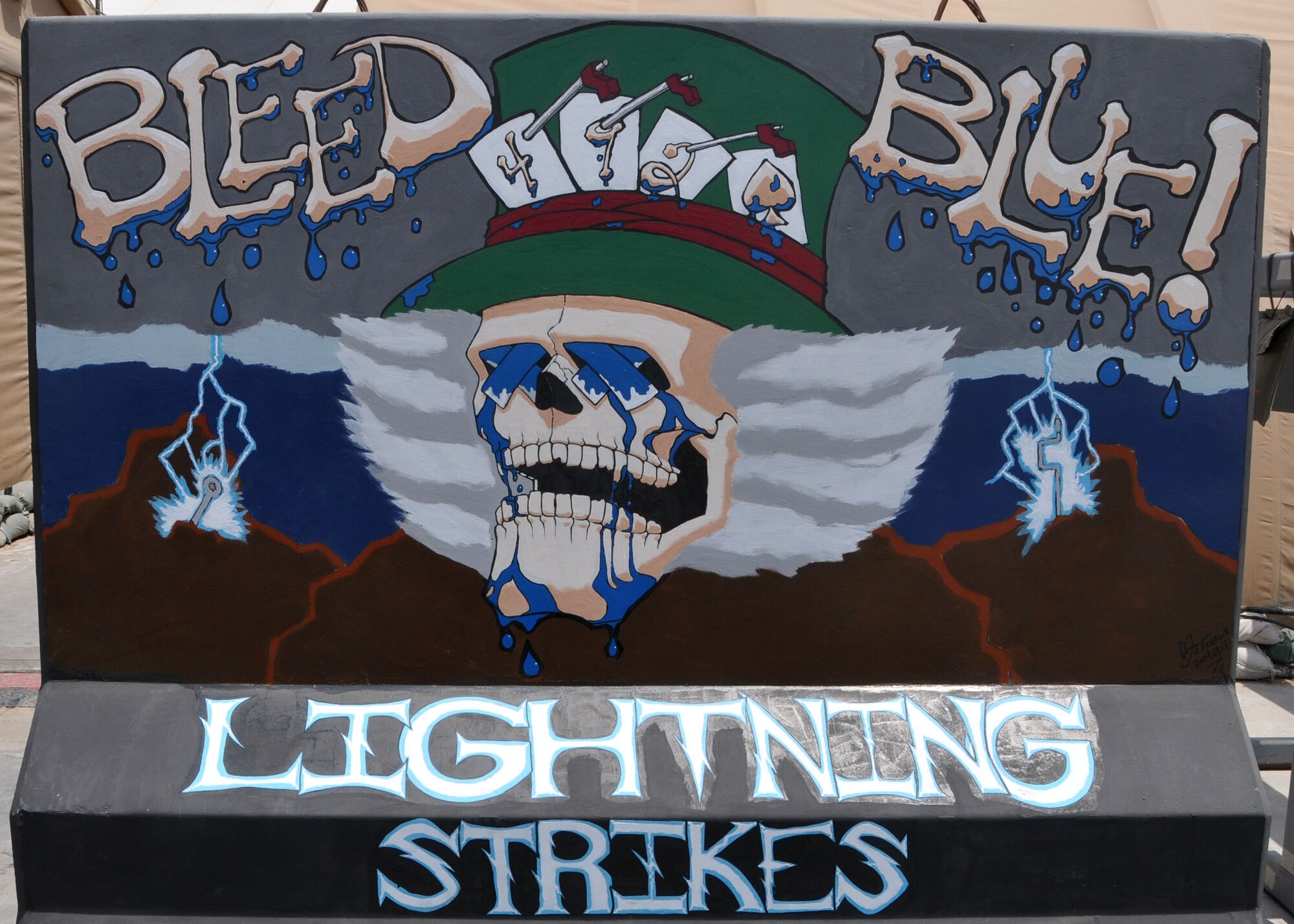 Air Force Staff Sgt. Quentin Fedrick designed and painted an art mural on a barrier located near the flightline at the 380th Air Expeditionary Wing at an undisclosed area in Southwest Asia, Aug. 21, 2014. (U.S. Air National Guard photo by Senior Master Sgt. Eric Peterson/Released)