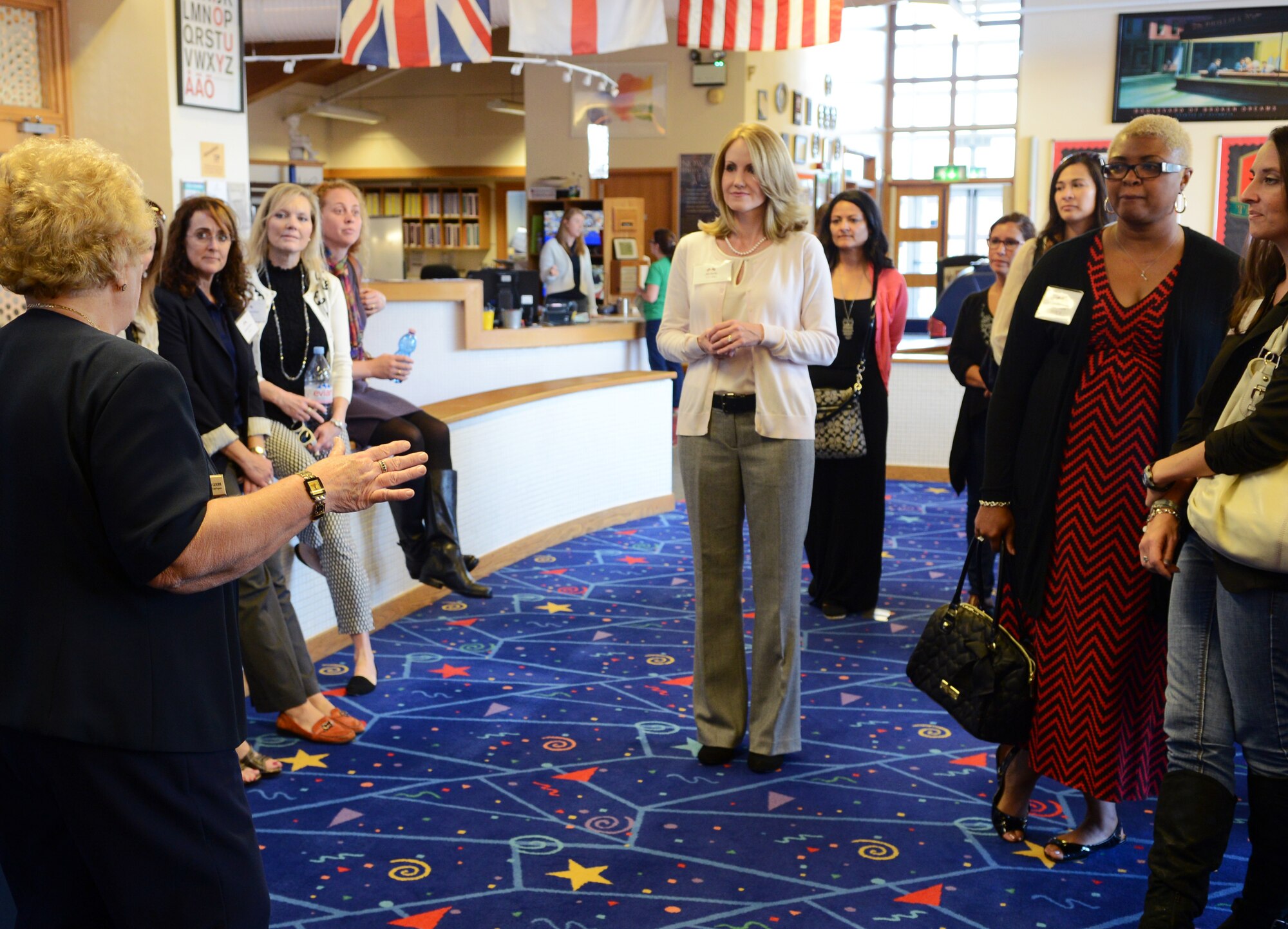 Team Mildenhall key spouses speak with Joan Goode, left, 100th Force Support Squadron Youth Programs director from London, in the youth center Sept. 12, 2014, on RAF Mildenhall, England. Goode showed off the facility and highlighted key components to the spouse group. (U.S. Air Force photo/Airman 1st Class Dillon Johnston/Released)