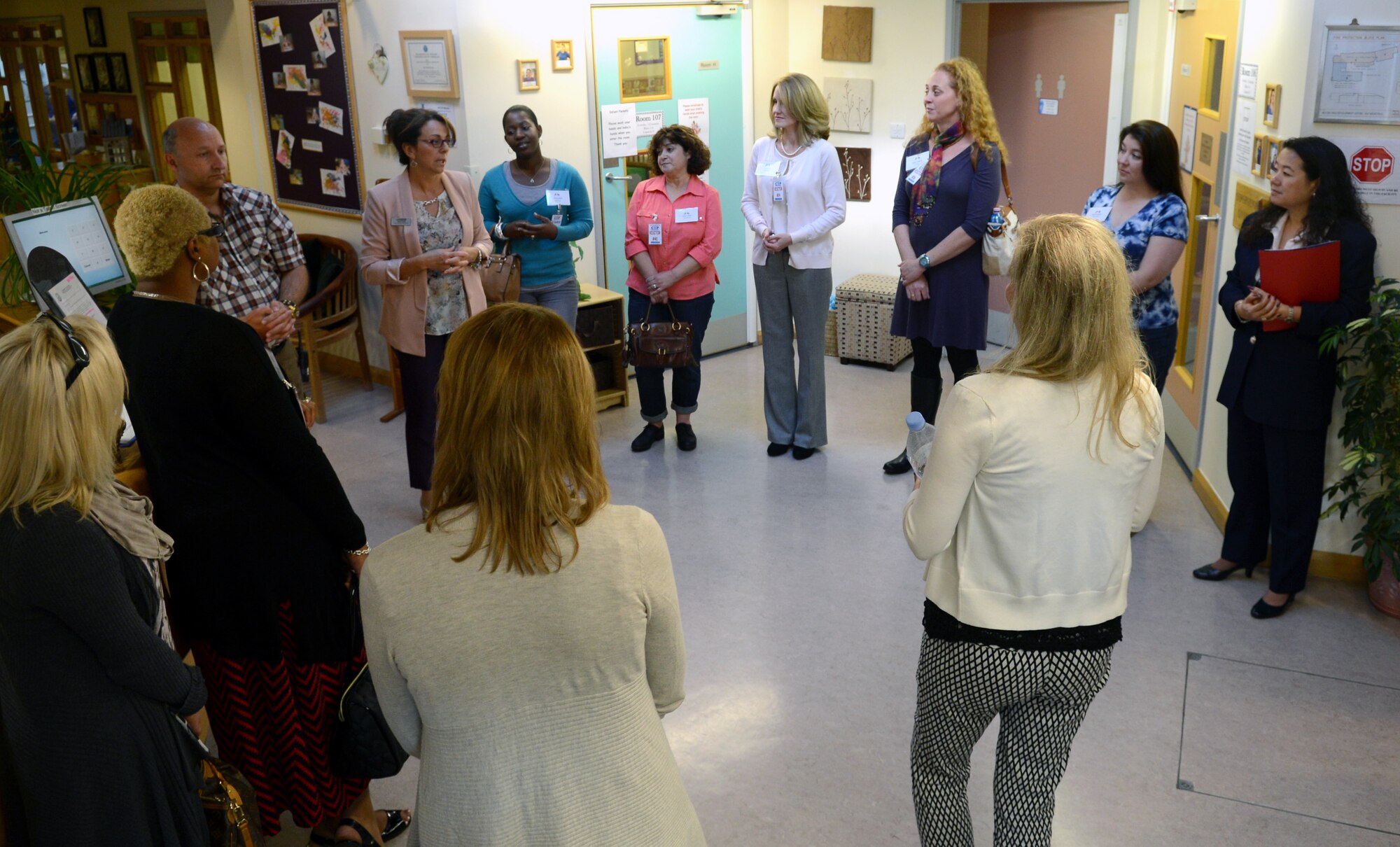 Team Mildenhall key spouses speak with Janet Evans, fourth from left, RAF Mildenhall Child Development Center chief, Sept. 12, 2014, at the CDC on RAF Mildenhall, England. The spouses toured the facility and learned about what it offers to service members and their dependents. (U.S. Air Force photo/Airman 1st Class Dillon Johnston/Released)