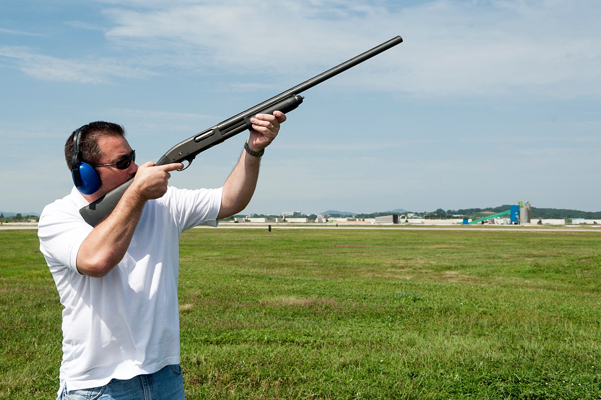 Michael Rosen, 51st Fighter Wing Bird Aircraft Strike Hazard program superintendent, shoots non-lethal burst shotgun rounds into the air at Osan Air Base, Republic of Korea, Sept. 9, 2014. These rounds are used to scare and disperse the birds away from the flightline. (U.S. Air Force photo by Senior Airman Matthew Lancaster)
