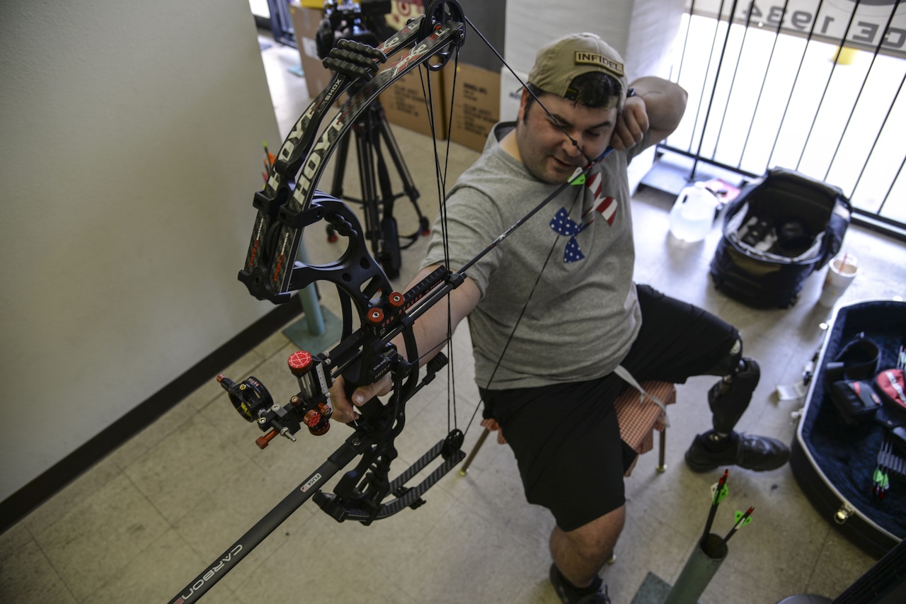 Air Force Staff Sgt. Seth Pena readies his compound bow to strike a target 25 meters away in San Antonio, Sept. 14, 2014. Pena will compete at the 2014 Warrior Games, taking place from Sept. 28 to Oct. 4, in Colorado Springs, Colo. U.S. Air Force photo by Senior Airman Michael Ellis