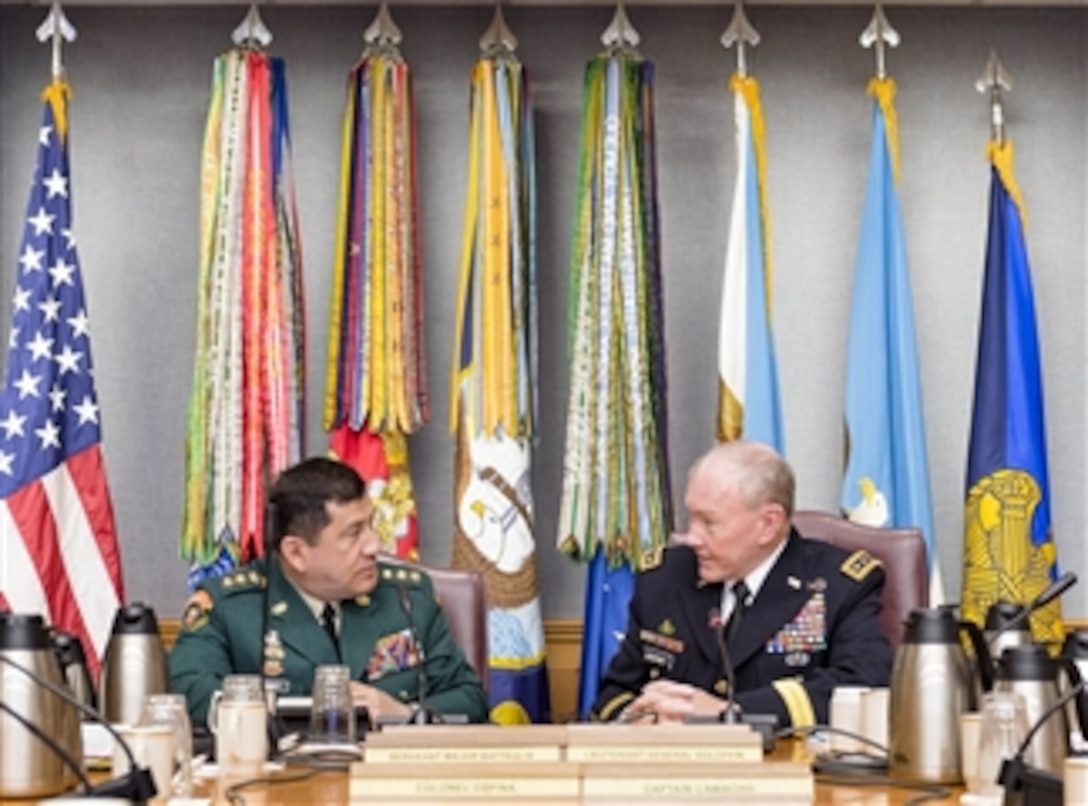 U.S. Army Gen. Martin E. Dempsey, right, chairman of the Joint Chiefs of Staff, meets with Colombian Army Gen. Juan Pablo Rodriguez Barragan, chief of Colombia's Joint Chiefs of Staff, at the Pentagon, Sept. 25, 2014. The two defense leaders met to discuss issues of mutual importance. 