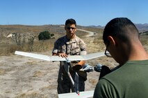 Lance Cpl. Anthony Galvan, 19, and Pfc. Brian Morales, 19, with 2nd Battalion, 5th Marine Regiment conduct pre-flight checks to the RQ-11B Raven (small unmanned surveillance system), aboard Marine Corps Base Camp Pendleton, Calif., Sept. 8-19. Infantry and intelligence Marines with 1st Marine Division witnessed the capabilities of the aircraft firsthand during a two-week introduction course to the SUASS which is used to acquire and relay timely, reliable information.
(USMC photo by Lance Cpl. Ashton C. Buckingham)