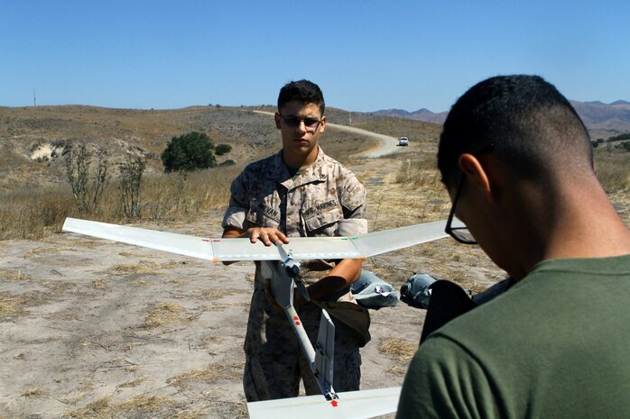 Lance Cpl. Anthony Galvan, 19, and Pfc. Brian Morales, 19, with 2nd Battalion, 5th Marine Regiment conduct pre-flight checks to the RQ-11B Raven (small unmanned surveillance system), aboard Marine Corps Base Camp Pendleton, Calif., Sept. 8-19. Infantry and intelligence Marines with 1st Marine Division witnessed the capabilities of the aircraft firsthand during a two-week introduction course to the SUASS which is used to acquire and relay timely, reliable information.
(USMC photo by Lance Cpl. Ashton C. Buckingham)