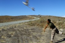 Private First Class Brian Morales, 19, the mission operator with 2nd Battalion, 5th Marine Regiment launches the RQ-11B Raven (small unmanned surveillance systems), aboard Marine Corps Base Camp Pendleton, Calif., Sept. 8-19. Infantry and intelligence Marines with 1st Marine Division witnessed the capabilities of the aircraft firsthand during a two-week introduction course to the SUASS which is used to pervade timely reliable information. (USMC photo by Lance Cpl. Ashton C. Buckingham)