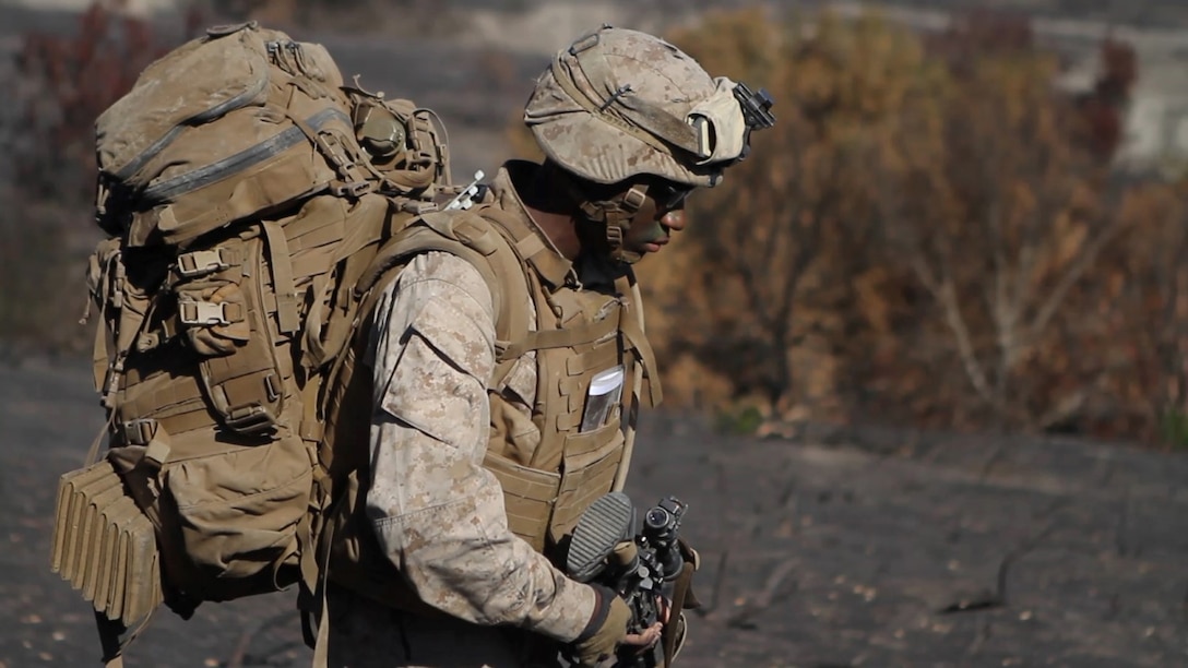 A rifleman with Company L, 3rd Battalion, 1st Marine Regiment, hikes to his company objective during the Marine Corps Combat Readiness Evaluation aboard Marine Corps Base Camp Pendleton, Calif., Sept. 23, 2014. The Marines were conducting operations to assess their operational capabilities in a deployed environment. The Marines spent five days hiking, providing security and setting defensive postures.