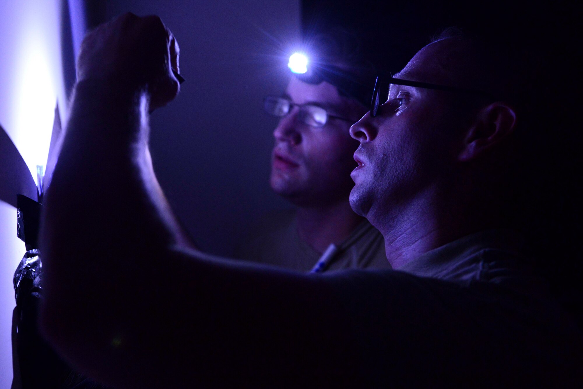 U.S. Air Force Airmen from the 379th Expeditionary Medical Group set up medical equipment for an exercise at Al Udeid Air Base, Qatar, Sept. 24, 2014. The exercise tested their response time to receiving casualties and how to work in low-light situations. (U.S. Air Force photo by Staff Sgt. Ciara Wymbs) 