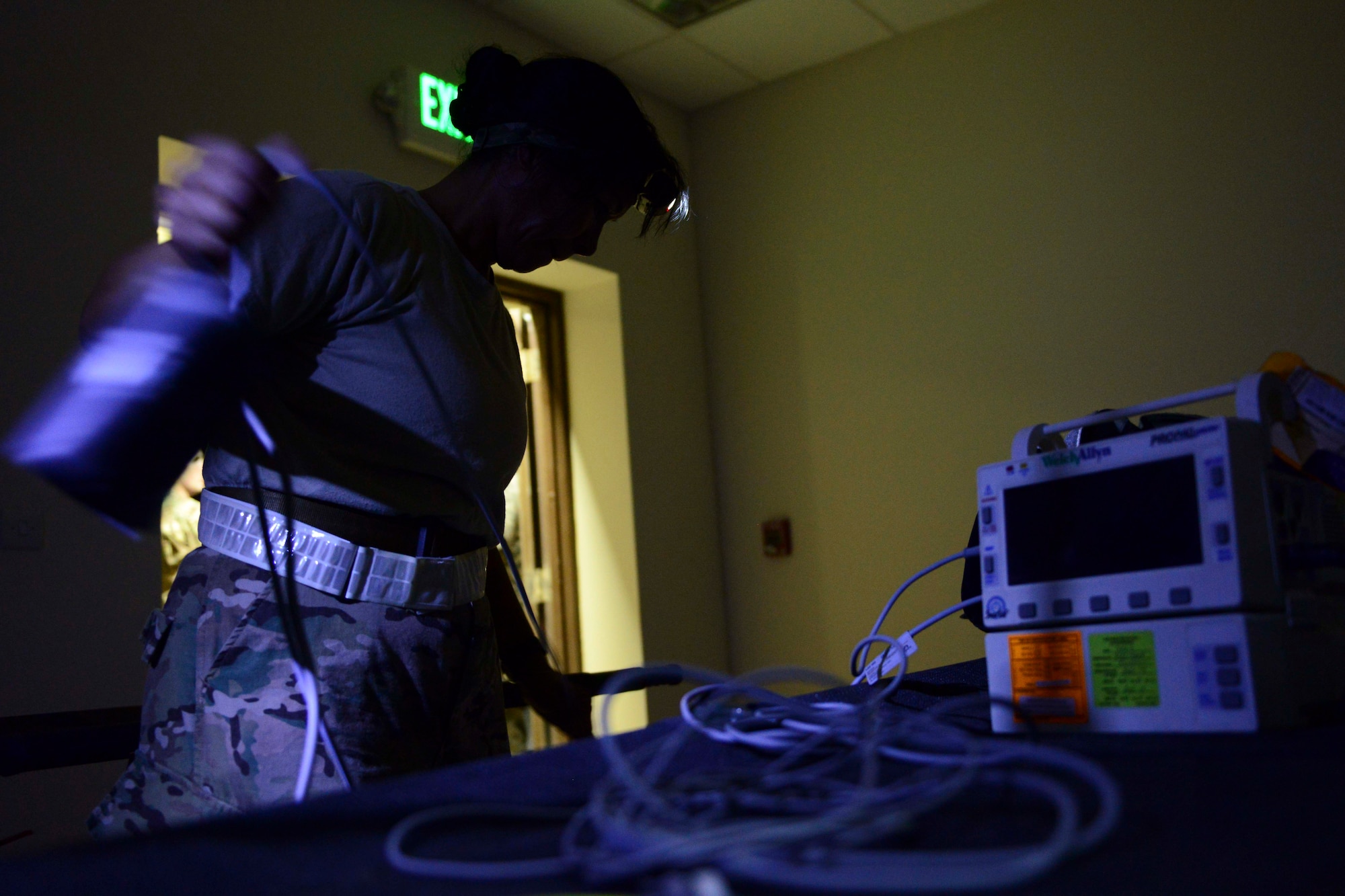 U.S. Air Force Maj. Michelle Dimoff, 379th Expeditionary Medical Operations Squadron critical care nurse, sets up medical supplies for an exercise at Al Udeid Air Base, Qatar, Sept. 24, 2014. The exercise tested the skills and abilities of medical staff on accuracy when dealing with injured persons. Dimoff is deployed from Nellis Air Force Base, Nevada. (U.S. Air Force photo by Staff Sgt. Ciara Wymbs)