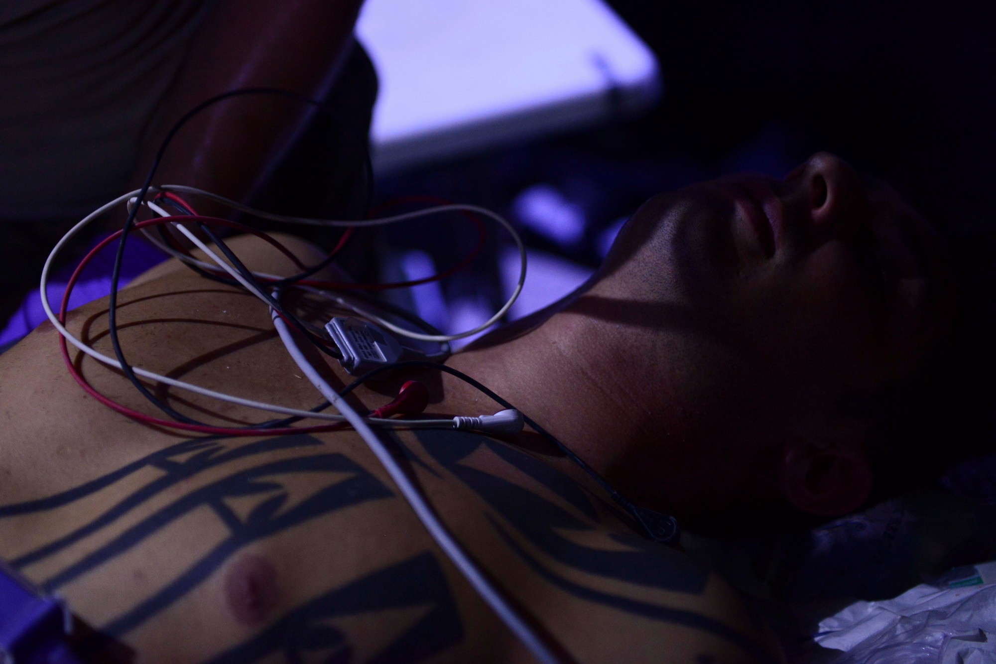 A simulated injured Service member rests during an exercise at Al Udeid Air Base, Qatar, Sept. 24, 2014. During the exercise Airmen used skills to treat casualties with minimal light and in an isolated area. (U.S. Air Force photo by Staff Sgt. Ciara Wymbs)