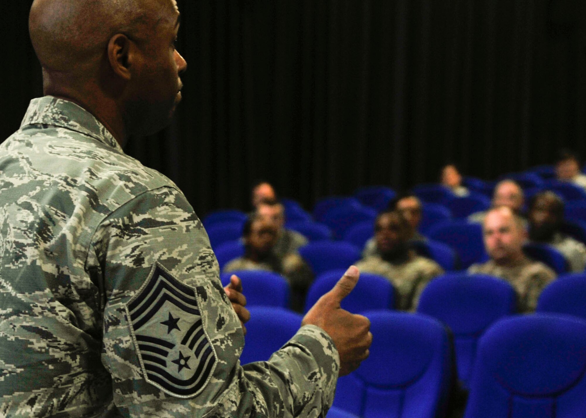 U.S. Air Force Chief Master Sgt. Danny Crudup, 379th Air Expeditionary Wing command chief, discusses some of the new changes to the enlisted Professional Military Education at Al Udeid Air Base, Qatar, Sept. 25, 2014. This program will develop from today's distance learning, multimedia, and telepresence concepts. (U.S. Air Force photo by Senior Airman Colin Cates)  