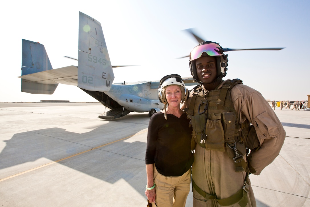 First Lady of the U.S. Marine Corps, Bonnie Amos, poses next to a Marine at Camp Arifjan, Kuwait, Sept. 5, 2014. Amos, Commandant of the U.S. Marine Corps, Gen. James F. Amos, and Sergeant Major of the Marine Corps, Sgt. Maj. Micheal P. Barrett, visited Marines to thank and update them on current events within the Marine Corps. (U.S. Marine Corps photo by Sgt. Gabriela Garcia/Released)