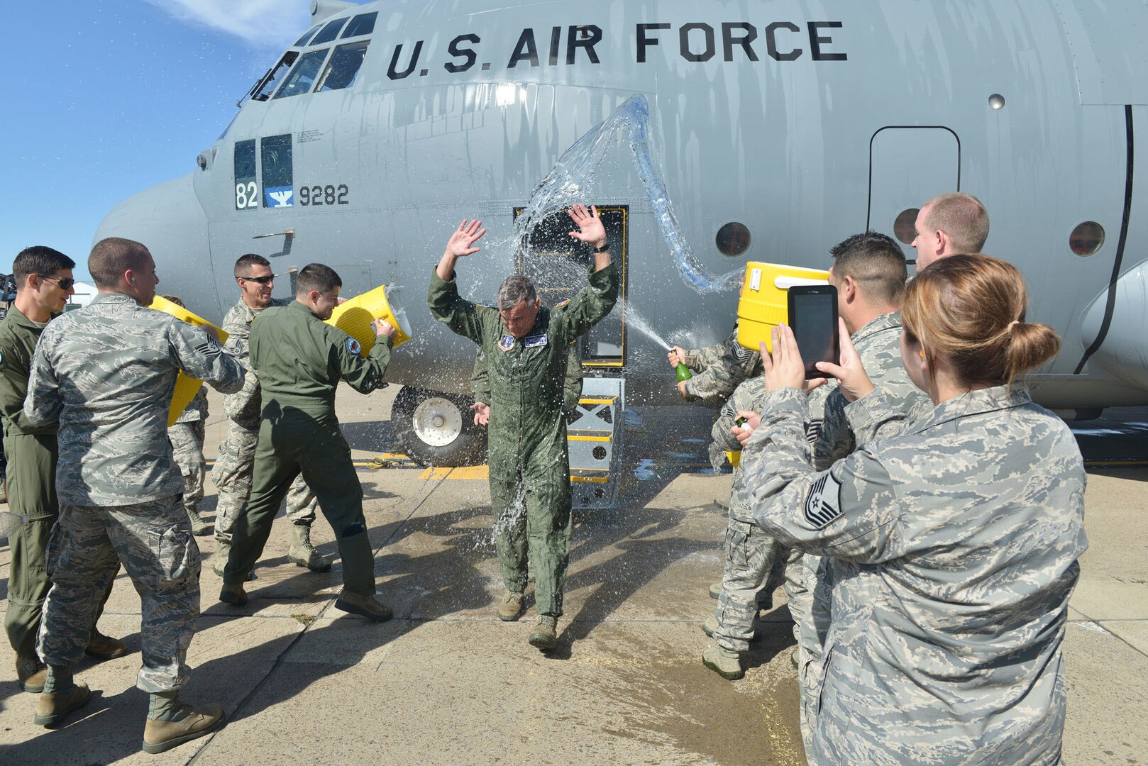 New York Air National Guard Col. John J. Higgins, commander of the 107th Airlift Wing, is doused by his comrades Sept. 25, 2014, as he steps off of the aircraft following his "fini flight," his final flight as a navigator. It was the 107th Airlift Wing's final flight in a C-130 before converting to the MQ-9 mission.