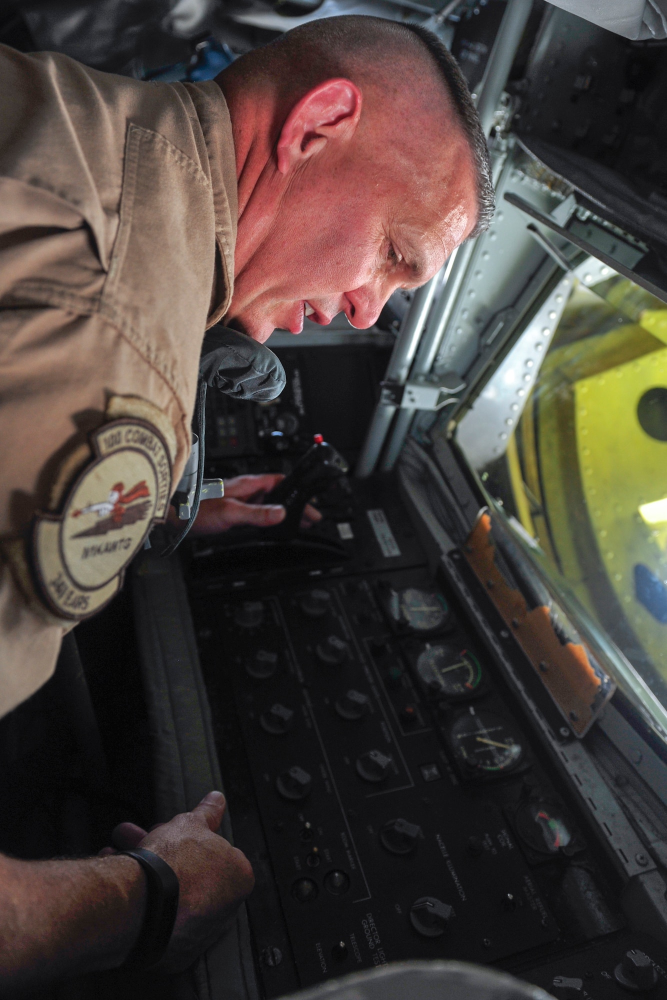 U.S. Air Force Senior Master Sgt. Brian Dillon 340th Expeditionary Air Refueling Squadron boom operator, looks over the controls of the boom in a KC-135 Stratotanker at Al Udeid Air Base, Qatar, Sept. 20, 2014. Dillon is deployed from the 190th Air Refueling Wing in Topeka, Kansas. His hometown is Niagara Falls, New York. (U.S. Air Force photo by Senior Airman Colin Cates)  