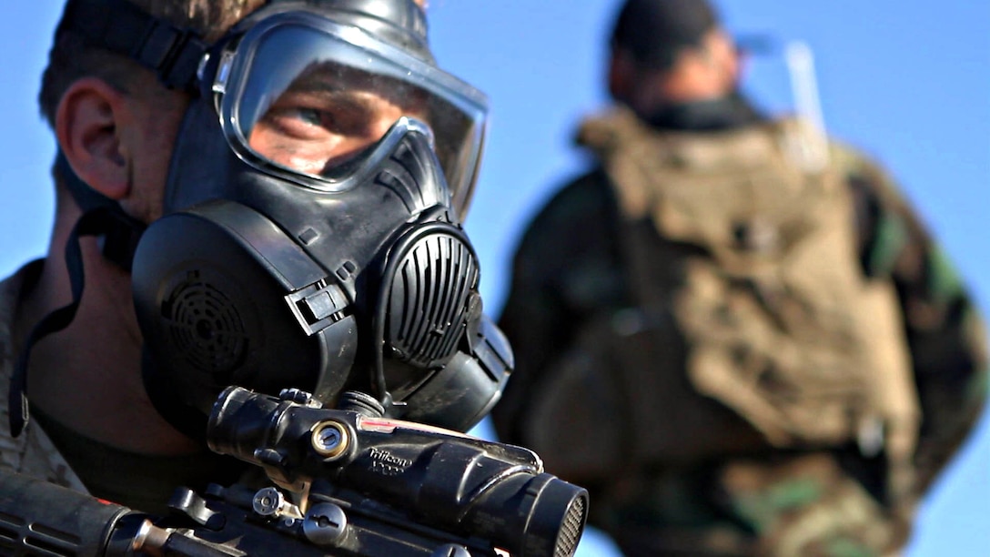 Riflemen with Company L, 3rd Battalion, 1st Marine Regiment, prepare for gas drills during the Marine Corps Combat Readiness Evaluation aboard Marine Corps Base Camp Pendleton, California, Sept. 24, 2014. The MCCRE is designed to be a final evaluation to ensure the Marines are prepared to be deployed. The battalion is slated to deploy as the ground combat element of the 15th Marine Expeditionary Unit next year.