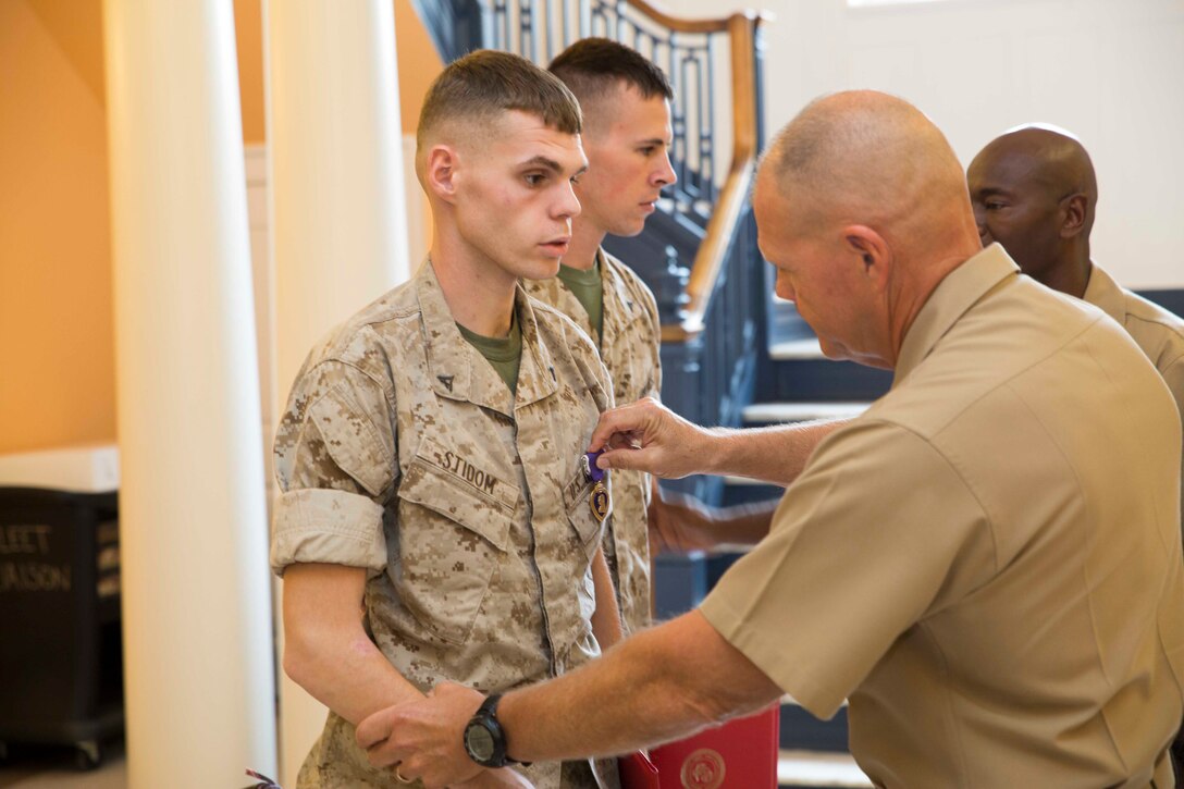 PORTSMOUTH, Va. (Sept. 19, 2014) – Lt. Gen. Robert B. Neller presented Purple Heart medals to Lance Corporals William Simmons and Christopher Stidom in a ceremony at Naval Medical Center Portsmouth on Sept. 19, 2014. Both Marines are combat engineers and were with 2nd Combat Engineer Battalion stationed in Camp Lejeune. Simmons is a Lincoln, Neb. native and Stidom hails from Huntington, W. Va.