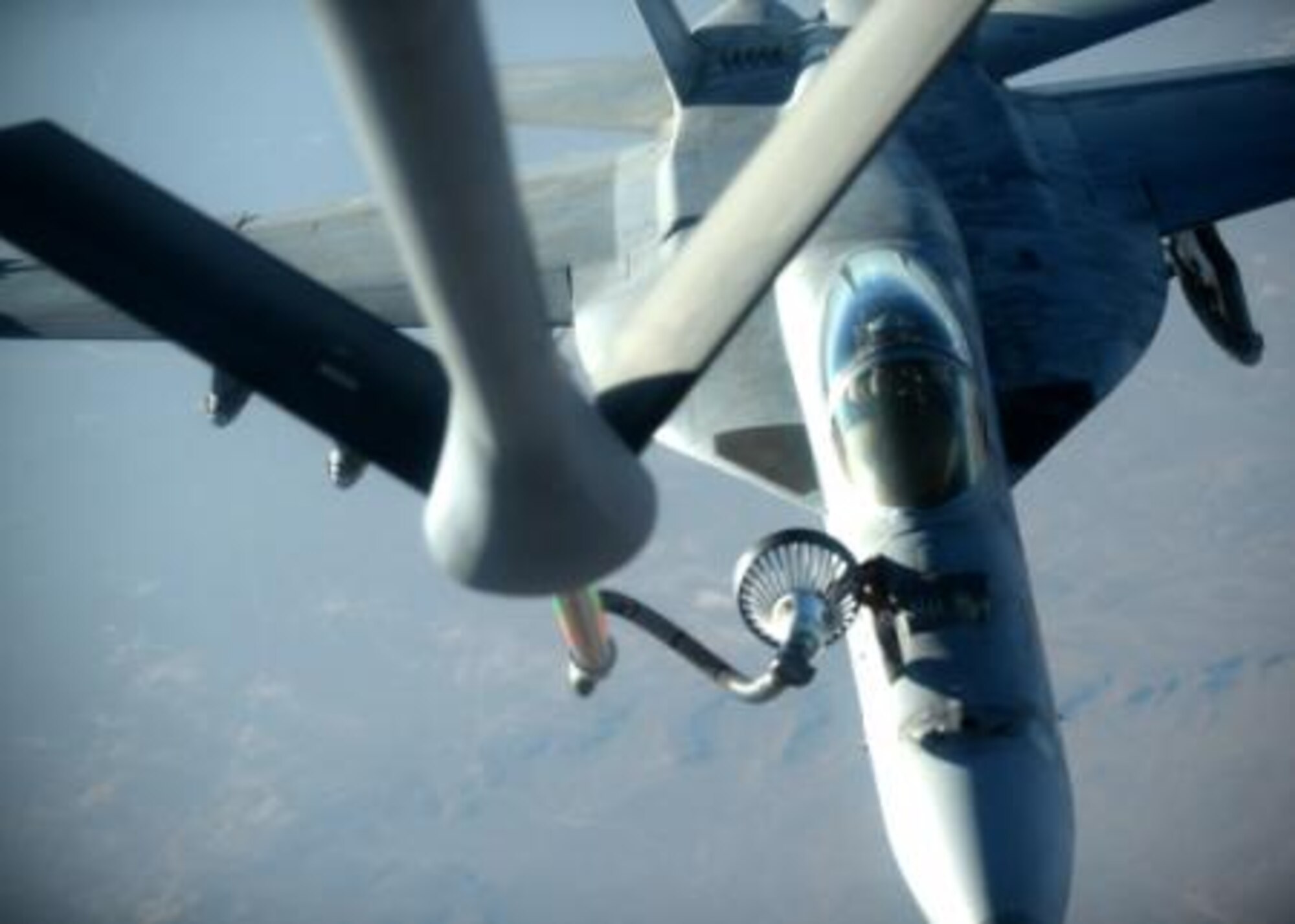 A U.S. Navy F-18E Super Hornet receives fuel from a KC-135 Stratotanker over northern Iraq after conducting air strikes in Syria, Sept. 23, 2014. These aircraft were part of a large coalition strike package that was the first to strike ISIL targets in Syria. (U.S. Air Force photo by Staff Sgt. Shawn Nickel)