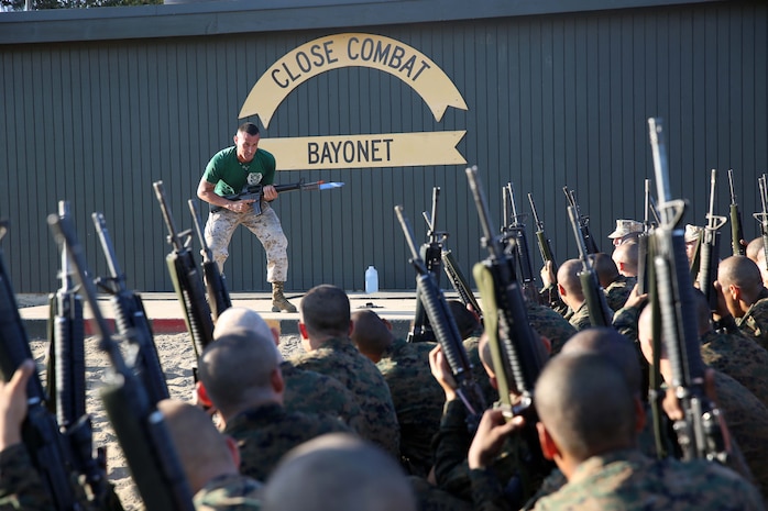 Recruits of Mike Company, 3rd Recruit Training Battalion, are shown the proper stance prior to a bayonet strike at Marine Corps Recruit San Diego, Calif., Sept. 24. Recruits were given a class on how utilize their rifle in close quarters combat with a fixed bayonet. 