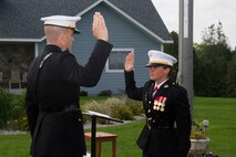 Capt. Chad Luebke, Officer Selection Officer of Recruiting Station Milwaukee, administers the Officer Oath of Office to 2nd Lt. Louise Nowak during her commissioning ceremony in Pound, Wis., on Sept. 20, 2014.  Nowak, a recent graduate of Carroll University, was awarded the Commandant’s Trophy earlier this year in recognition of her exceptional academic performance, physical fitness and leadership at Officer Candidate School in Quantico, Va.