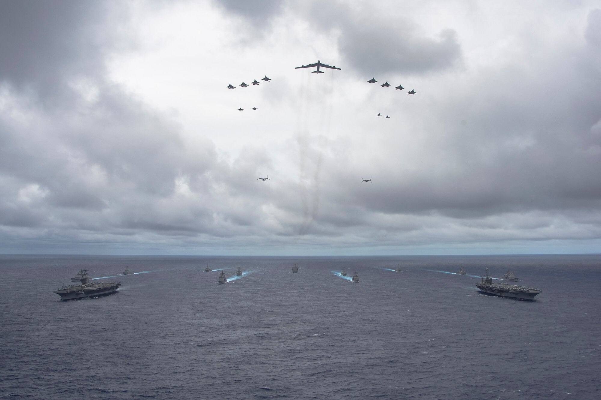 Ships from the George Washington and Carl Vinson Carrier Strike Groups and aircraft from the Air Force and Marine Corps operate in formation at the conclusion of Valiant Shield 2014. Valiant Shield is a U.S.-only exercise integrating Navy, Air Force, Army, and Marine Corps assets, offering real-world joint operational experience to develop capabilities that provide a full range of options to defend U.S. interests and those of its allies and partners. (U.S. Navy photo by Mass Communication Specialist 1st Class Trevor Welsh)