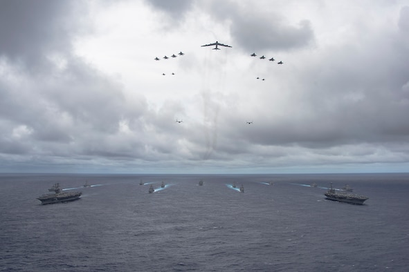Ships from the George Washington and Carl Vinson Carrier Strike Groups and aircraft from the Air Force and Marine Corps operate in formation at the conclusion of Valiant Shield 2014. Valiant Shield is a U.S.-only exercise integrating Navy, Air Force, Army, and Marine Corps assets, offering real-world joint operational experience to develop capabilities that provide a full range of options to defend U.S. interests and those of its allies and partners. (U.S. Navy photo by Mass Communication Specialist 1st Class Trevor Welsh)