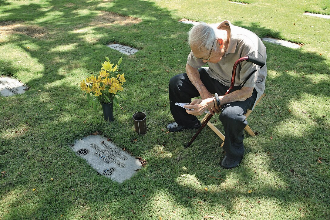 HONOLULU - Retired United States Army Lt. Gen Allen K. Ono sits at his wife’s headstone during at the National Memorial Cemetery of the Pacific, Sept. 19, 2014. Service members, veterans and civilians met at the cemetery for National Prisoner of War/Missing in Action Recognition Day. A ceremony was conducted to honor the service members who have spent time in a POW camp, and those are still missing. (U.S. Marine Corps photo by Lance Cpl. Adam O. Korolev)