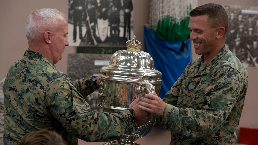 Col. Timothy Parker, the commanding officer of Weapons and Training Battalion, Marine Corps Base Quantico, Va. presents the Duke of Edinburgh Cup to Capt. Jared Dalton, the team captain of the U.S. Marine Corps Shooting team, during the awards ceremony of the Royal Marines Operational Shooting Command at Altcar Range near Hightown, England, Sept. 18, 2014. The Duke of Edinburgh Cup is awarded to the team who has the highest Total rifle and pistol score. (U.S. Marine Corps photo by Cpl. Cameron Storm/Released)
