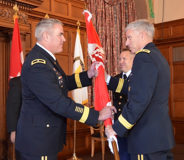 Maj. Gen. Richard L. Stevens, U.S. Army Corps of Engineers deputy commanding general, transfers the colors to Brig. Gen. Richard G. Kaiser, USACE Great Lakes and Ohio River Division commander, during an assumption of command ceremony Sept. 26, 2014 in Cincinnati, Ohio.