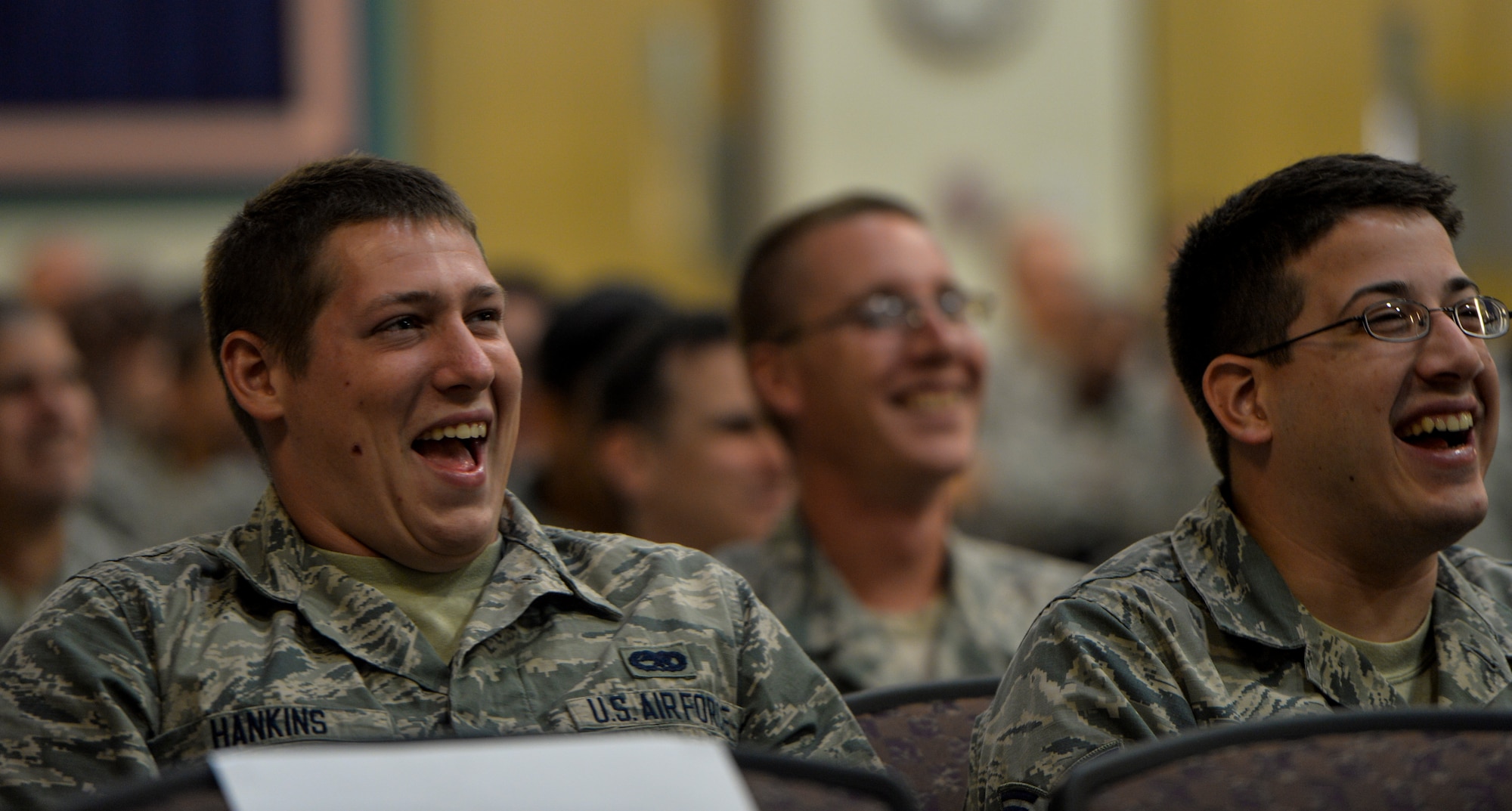 Airmen from Hurlburt Field laugh during resiliency training at Hurlburt Field, Fla. Sept. 24, 2014. Comedian Bernie McGrenahan spoke to Airmen about the importance of resiliency in a humor filled presentation. (U.S. Air Force photo/Senior Airman Christopher Callaway)  