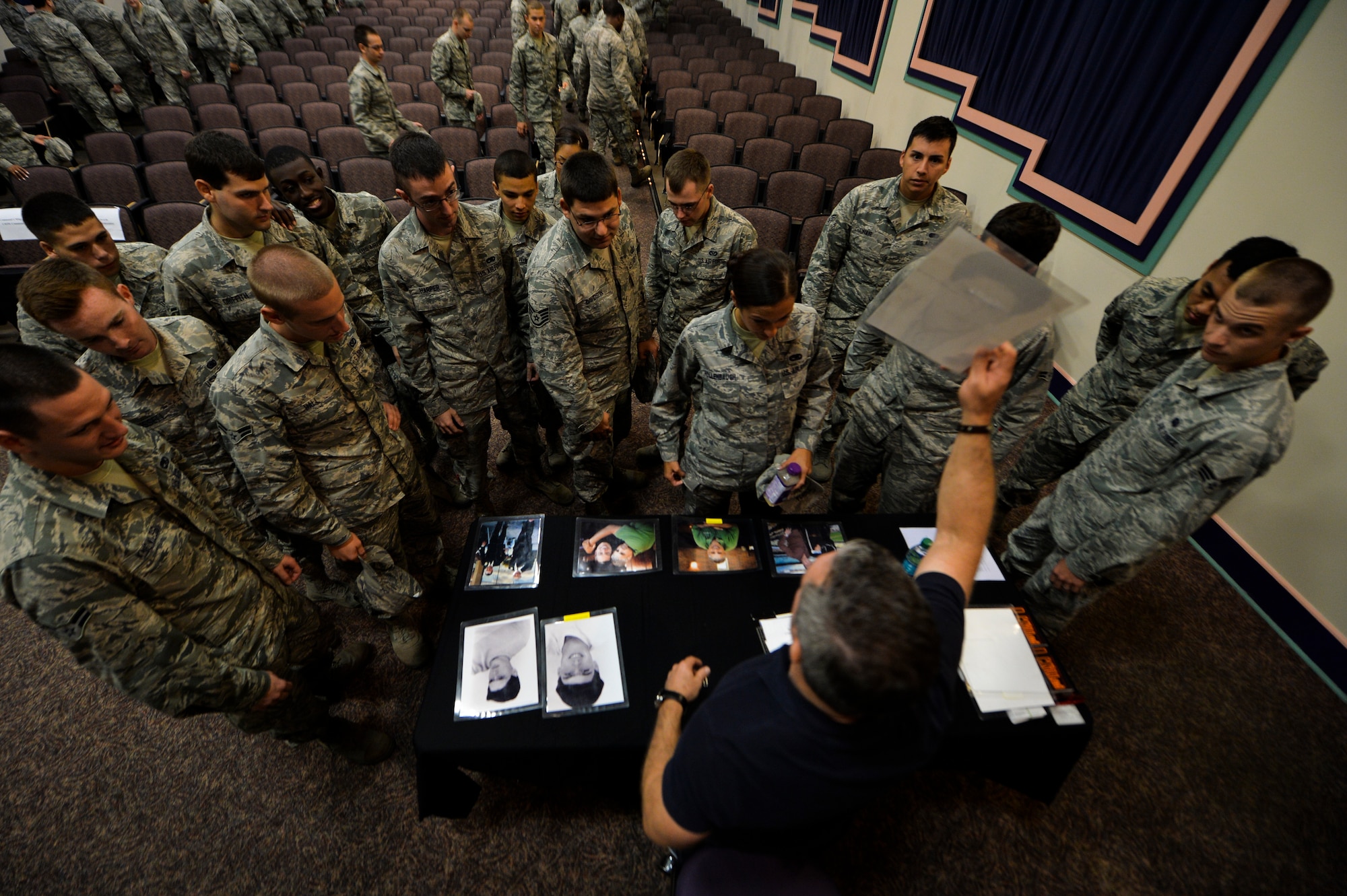 Comedian Bernie McGrenahan shows Airmen pictures of his family while at King Auditorium, Hurlburt Field, Fla., Sept. 24, 2014. McGrenahan spoke about the importance of resiliency in a humor filled presentation. (U.S. Air Force photo/Senior Airman Christopher Callaway)  
