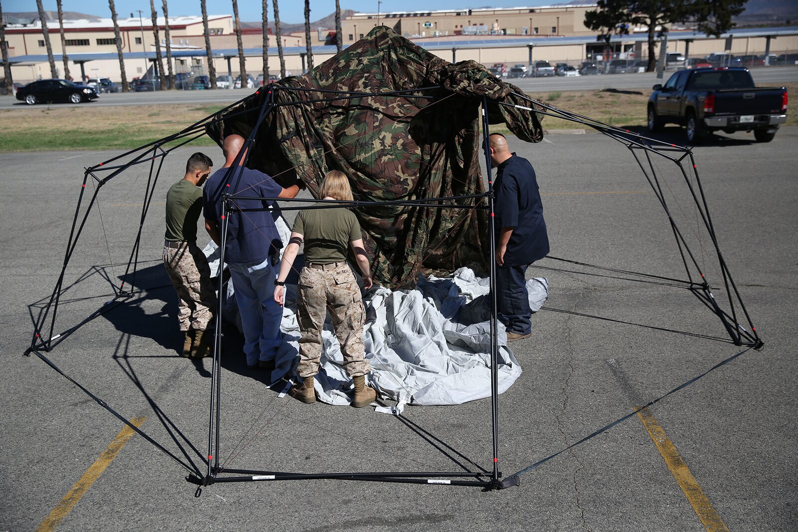 Marines and civilian contractors put together an Arctic shelter Aug. 29, 2014, aboard Camp Pendleton, California. The system is an ultra-lightweight, rapidly deployable shelter that offers military forces the necessary infrastructure to operate in austere cold-weather locations. The system is being used for training exercises in Bridgeport, California, and is slated to be integrated into exercises early next year. (U.S. Marine Corps photo by Sgt. Laura Gauna/released)