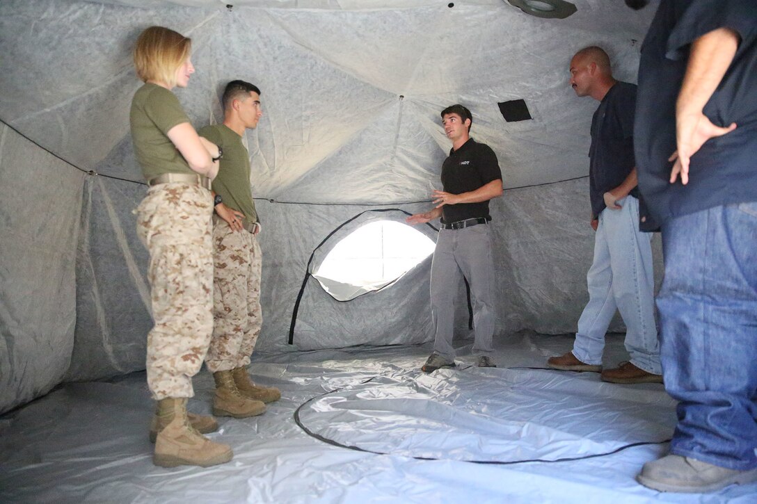 Marines and civilian contractors stand inside an Arctic shelter Aug. 29, 2014, aboard Camp Pendleton, California. The system is an ultra-lightweight, rapidly deployable shelter that offers military forces the necessary infrastructure to operate in austere cold-weather locations. The system is being used for training exercises in Bridgeport, California, and is slated to be integrated into exercises early next year. (U.S. Marine Corps photo by Sgt. Laura Gauna/released)