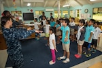 SAIPAN (Sept. 25, 2014) - Sailors assigned to the Ticonderoga-class guided-missile cruiser USS Shiloh (CG 67) perform jumping-jacks with students at the Brilliant Star Montessori School in Saipan during a cultural exchange. Shiloh is in Saipan for a scheduled port visit after participating in Valiant Shield, a U.S.-only exercise integrating 18,000 U.S. Navy, Air Force, Army, and Marine Corps personnel, more than 200 aircraft and 19 surface ships, offering real-world joint operational experience to develop capabilities that provide a full range of options to defend U.S. interests and those if its allies and partners. 140925-N-UF697-027 