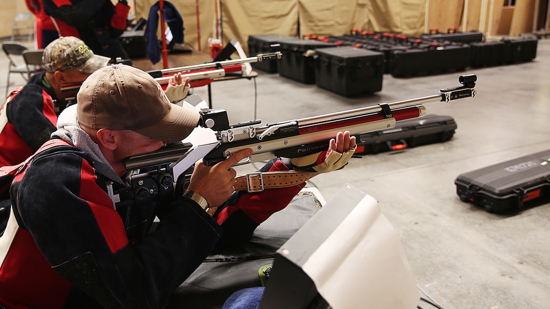 Hospitalman First Class Jamie Sclater, a native to Annandale, Virginia, aims down range with other shooters during shooting practice for the Marine team, September 24, in preparation for the 2014 Warrior Games. The Marine team has been training since September 15 in order to build team cohesion and acclimate to the above 6,000 ft. altitude of Colorado Springs.  The Marine team is comprised of both active duty and veteran wounded, ill and injured Marines who are attached to or supported by the Wounded Warrior Regiment, the official unit of the Marine Corps charged with providing comprehensive non-medical recovery care to wounded, ill and injured Marines.  