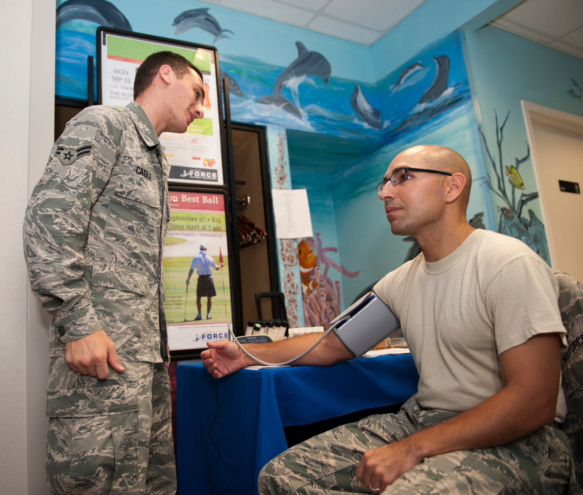 Airman 1st Class Justin Cagle, 1st Special Operations Aerospace Medicine Squadron, checks Chief Master Sgt. Manuel Martinez’s, 1st Special Operations Force Support Squadron superintendent, blood pressure during the Go for Green evet at The Reef dining facility on Hurlbrut Field, Fla., Sept. 22, 2014. Evaluations of different health factors were offered  during the event to give Airmen an overall view of their health. (U.S. Air Force photo/Senior Airman Krystal M. Garrett)