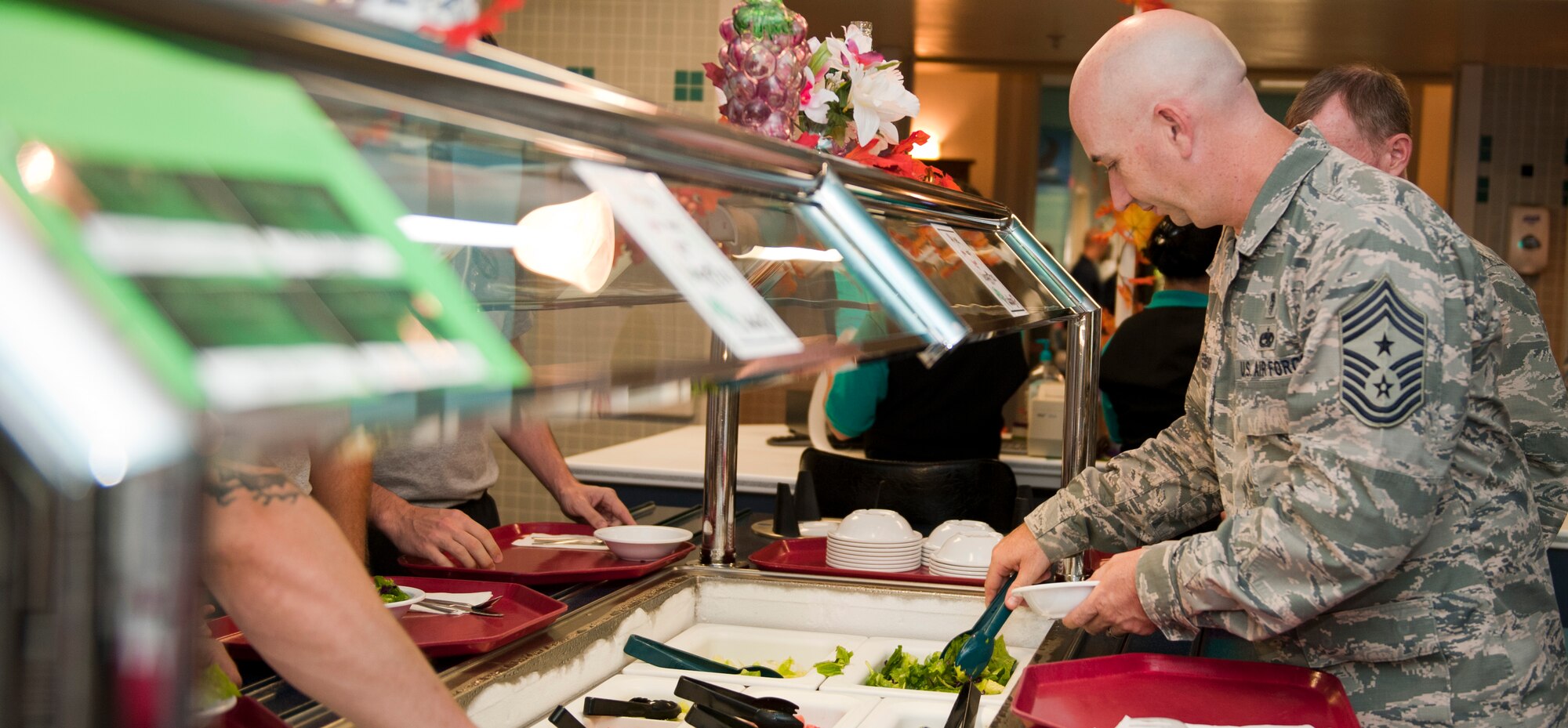 Chief Master Sgt. Jeff Maberry, 1st Special Operations Wing command chief, prepares a salad during the Go for Green event at Th Reef dining facility on Hurlburt Field, Fla., Sept. 22, 2014. Consistent practice of healthy eating and exercising play a crucial role in overall combat readiness. (U.S. Air Force photo/Senior Airman Kystal M. Garrett)