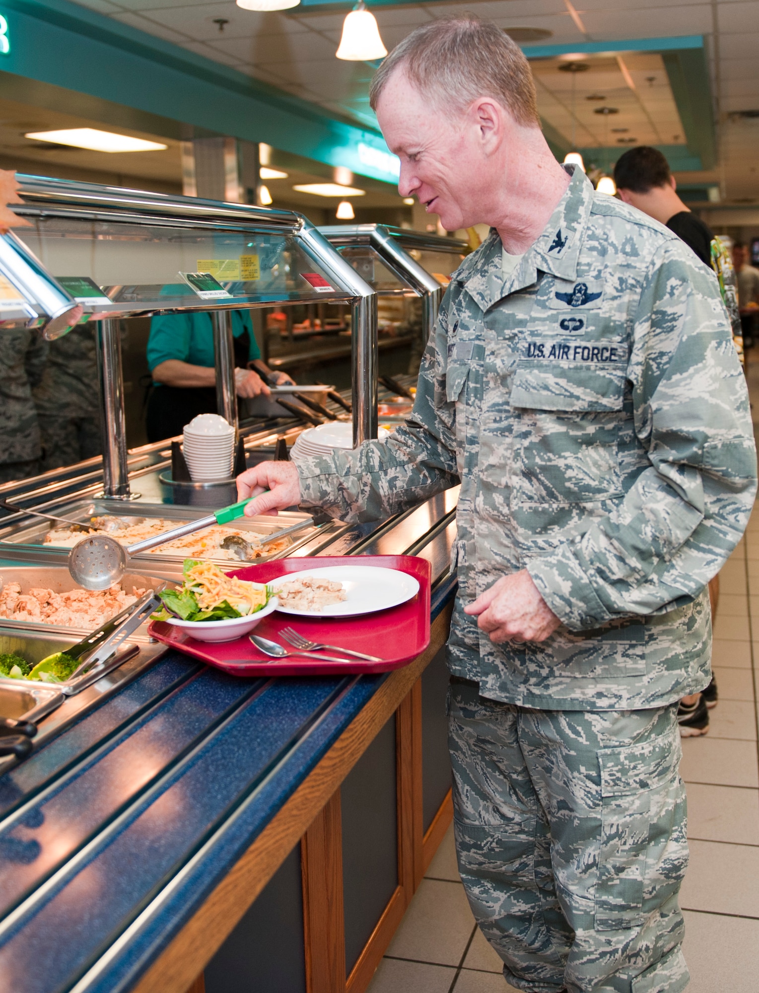 Col. Bill West, 1st Special Operations Wing commnder, prepares a plate during the Go for Green event at The Reef dining facility on Hurlburt Field, Fla., Sept. 22. 2014. Consistent practice of healthy eating and exercising play a crucial role in overall combat readiness. (U.S. Air Force photo/Senior Airman Krystal M. Garrett)