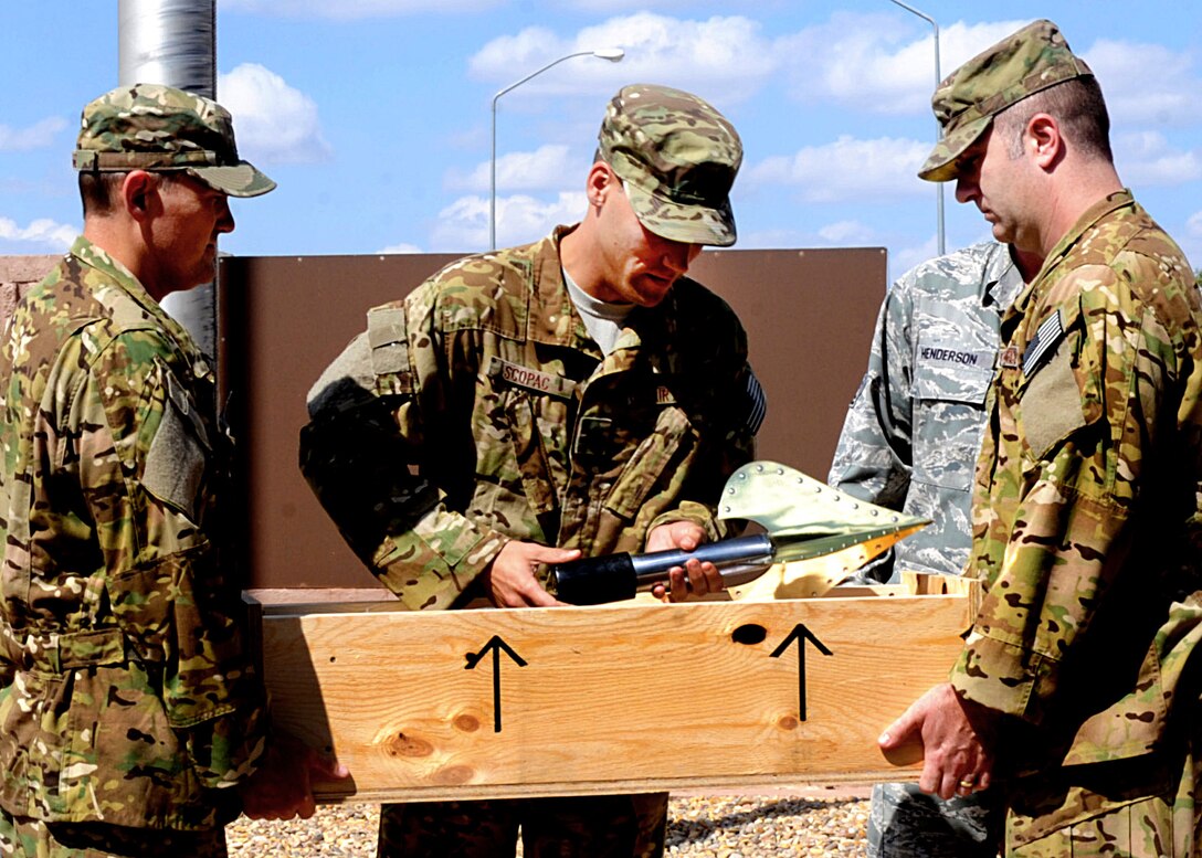 U.S. Air Force Lt. Col. Nathan Scopac, 522nd Special Operations Squadron commander, lifts a finial memorializing Tech. Sgt. William Jefferson, 21st Special Tactics Squadron combat controller, from its box after a ceremony Sept. 26, 2014 at Cannon Air Force Base, N.M. The finial now sits in a place of honor atop a flag pole near Cannon’s main gate. (U.S. Air Force photo/Senior Airman Ericka Engblom)