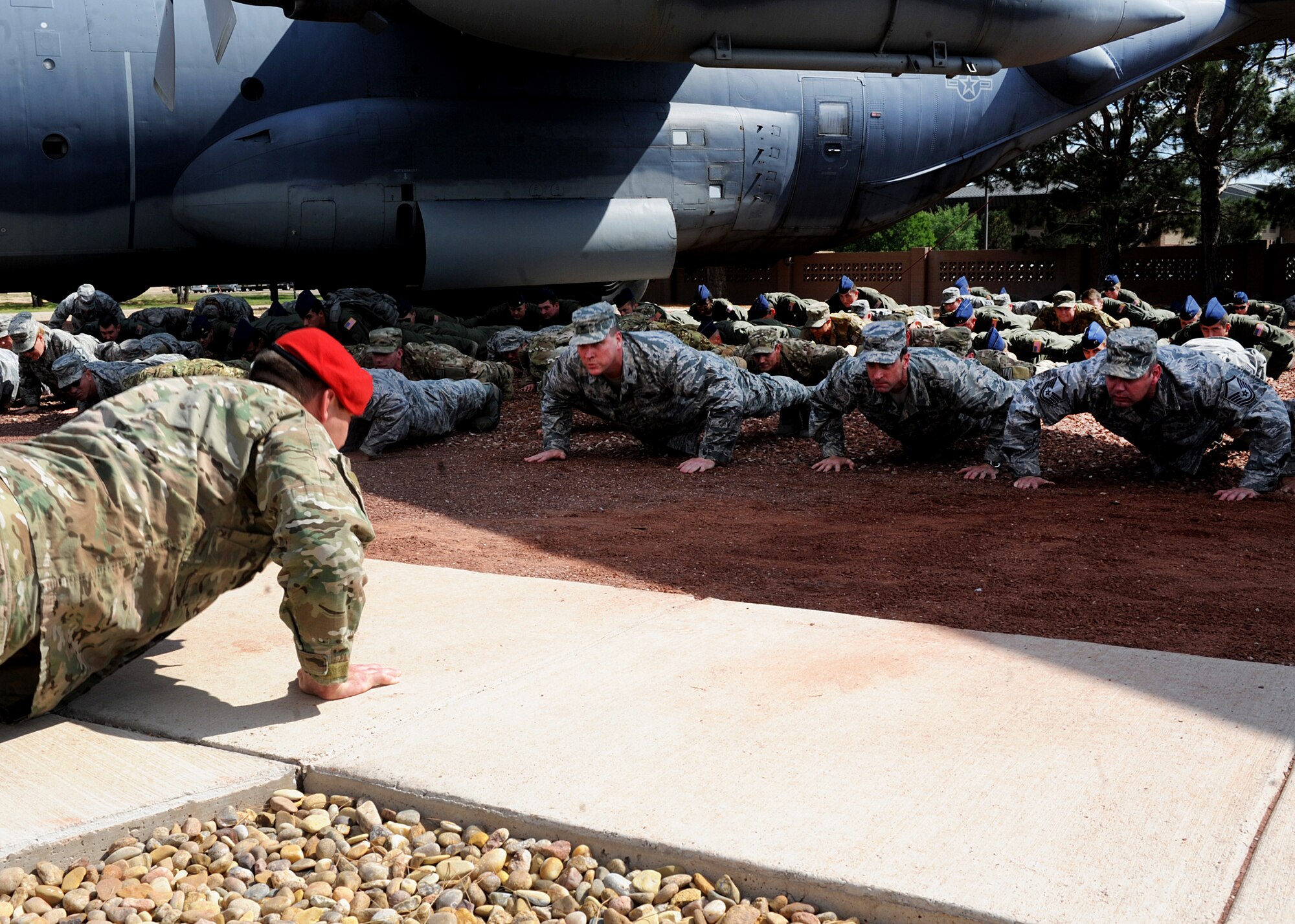 U.S. Air Force Tech. Sgt. Robert Guiterez, 26th Special Tactics Squadron combat controller, leads the crowd in memorial push-ups during a ceremony Sept. 26, 2014 at Cannon Air Force Base, N.M. The ceremony was held in honor of Tech. Sgt. William Jefferson, 21st Special Tactics Squadron combat controller, who gave his life while defending our country overseas. (U.S. Air Force photo/Senior Airman Ericka Engblom)