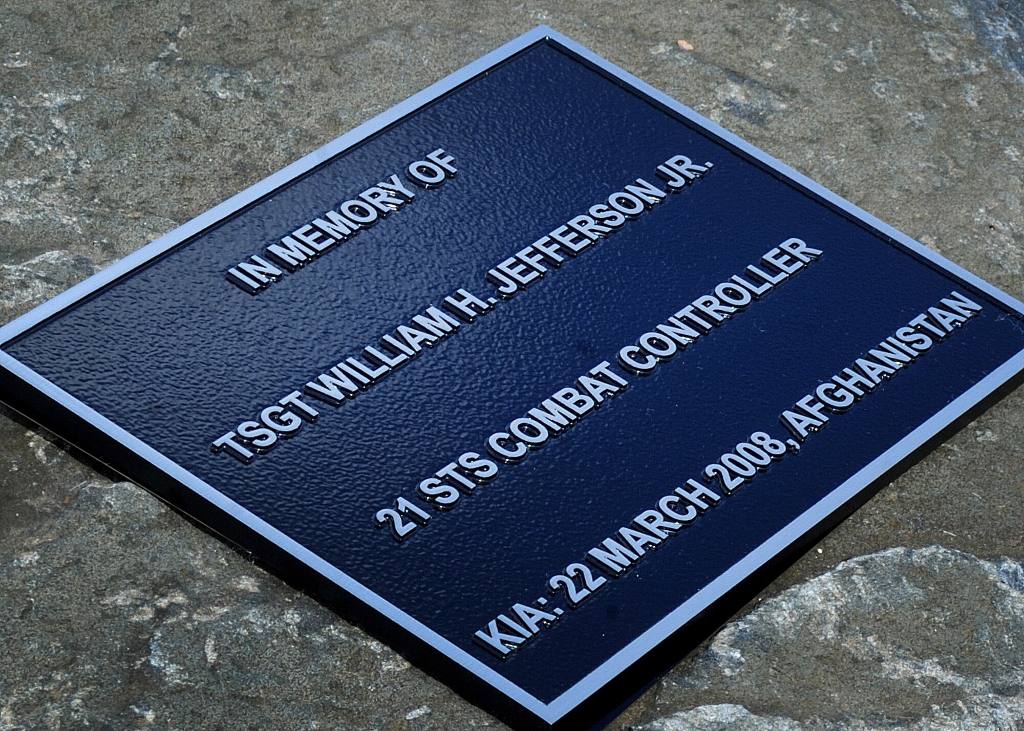 A plaque memorializing the sacrifice of Tech. Sgt. William Jefferson, 21st Special Tactics Squadron combat controller, is placed before a flag pole Sept. 26, at Cannon Air Force Base, N.M. Jefferson’s memorial previously resided in Afghanistan where Jefferson died defending our country. (U.S. Air Force photo/Senior Airman Ericka Engblom)