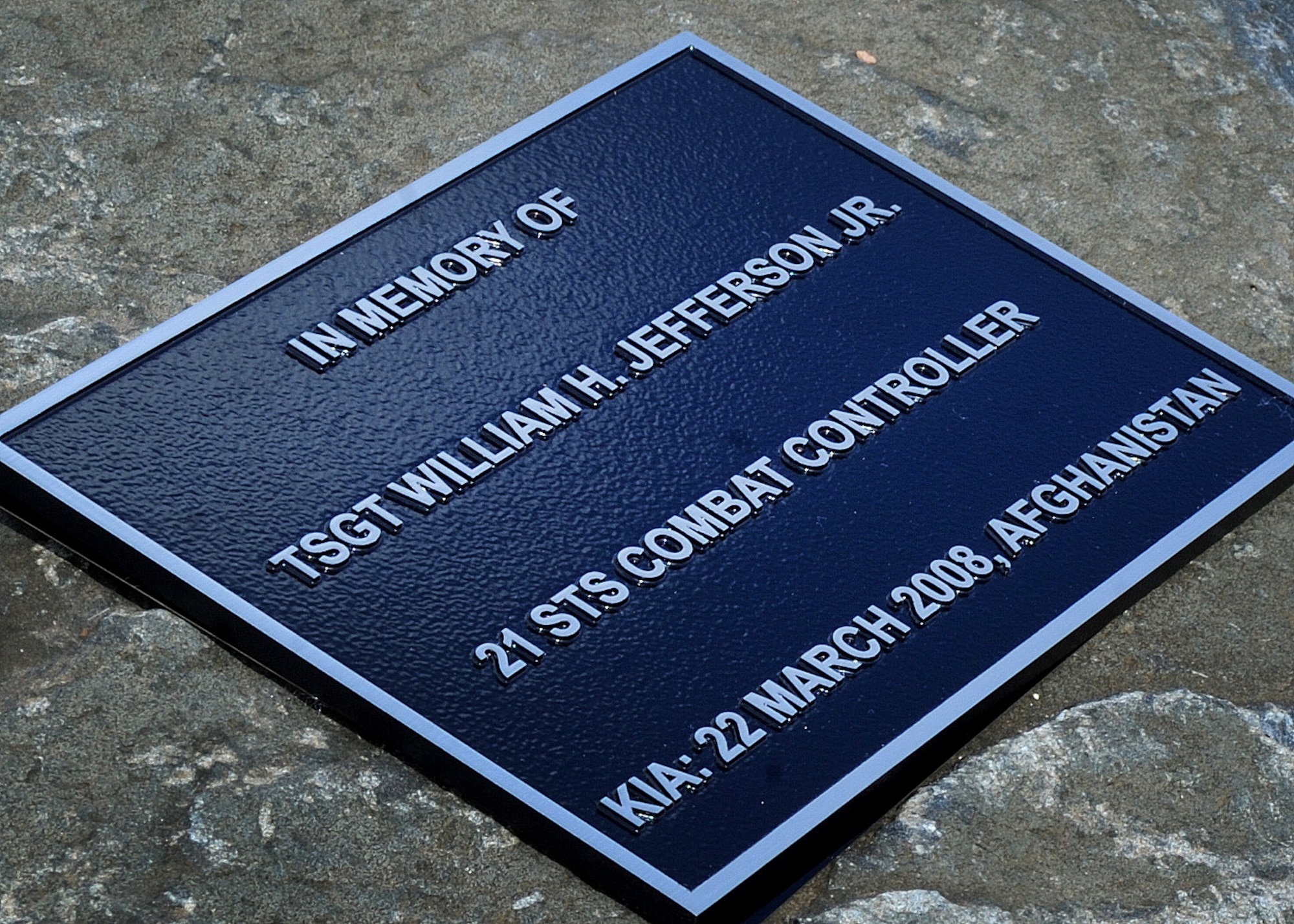 A plaque memorializing the sacrifice of Tech. Sgt. William Jefferson, 21st Special Tactics Squadron combat controller, is placed before a flag pole Sept. 26, at Cannon Air Force Base, N.M. Jefferson’s memorial previously resided in Afghanistan where Jefferson died defending our country. (U.S. Air Force photo/Senior Airman Ericka Engblom)