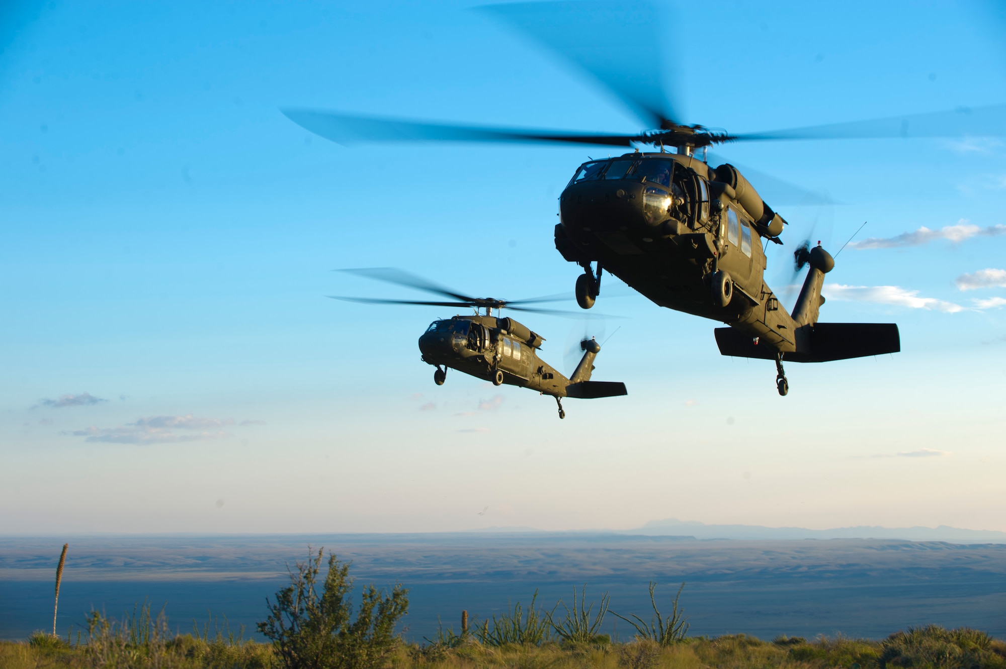 U.S. Army UH-60M Black Hawk Helicopters fly overhead during a training exercise at Holloman Air Force Base, N.M, 25 Sept. Soldiers from the 101st Airborne Division use the Holloman and White Sands Missile Range training ranges to conduct a Hostile Environment Medical Training Course, designed specifically for Close Protection Operations during deployments to high threat regions throughout the world. (U.S. Air Force photo by Airman 1st Class Chase Cannon/ Released)

