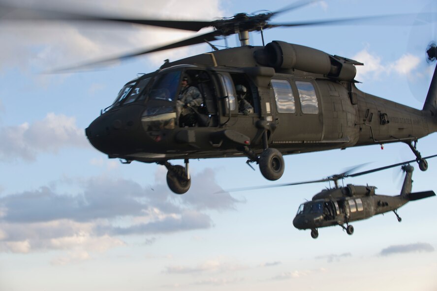 U.S. Army UH-60M Black Hawk Helicopters fly overhead during a training exercise at Holloman Air Force Base, N.M, 25 Sept. Soldiers from the 101st Airborne Division use the Holloman and White Sands Missile Range training ranges to conduct a Hostile Environment Medical Training Course, designed specifically for Close Protection Operations during deployments to high threat regions throughout the world. (U.S. Air Force photo by Airman 1st Class Chase Cannon/ Released)