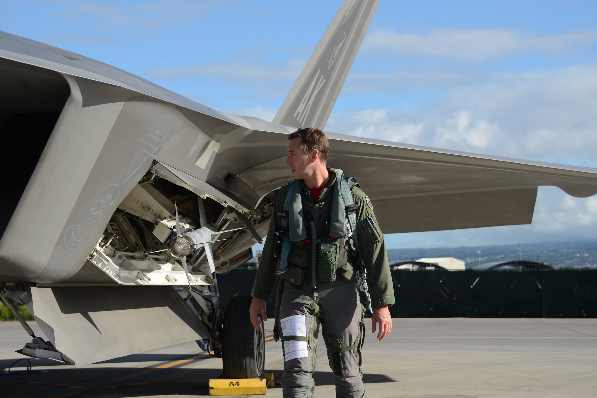 Lt. Col. Chad Feucht, a Reserve F-22 pilot, conducts his final walk around inspection prior to his sortie Sept 6, 2014. The 477th Fighter Group is Alaska's only Air Force Reserve unit and has just returned from its first ever group-wide off station annual tour at Joint Base Pearl Harbor Hickam, Hawaii. (U.S. Air Force photo/Tech. Sgt. Dana Rosso)
