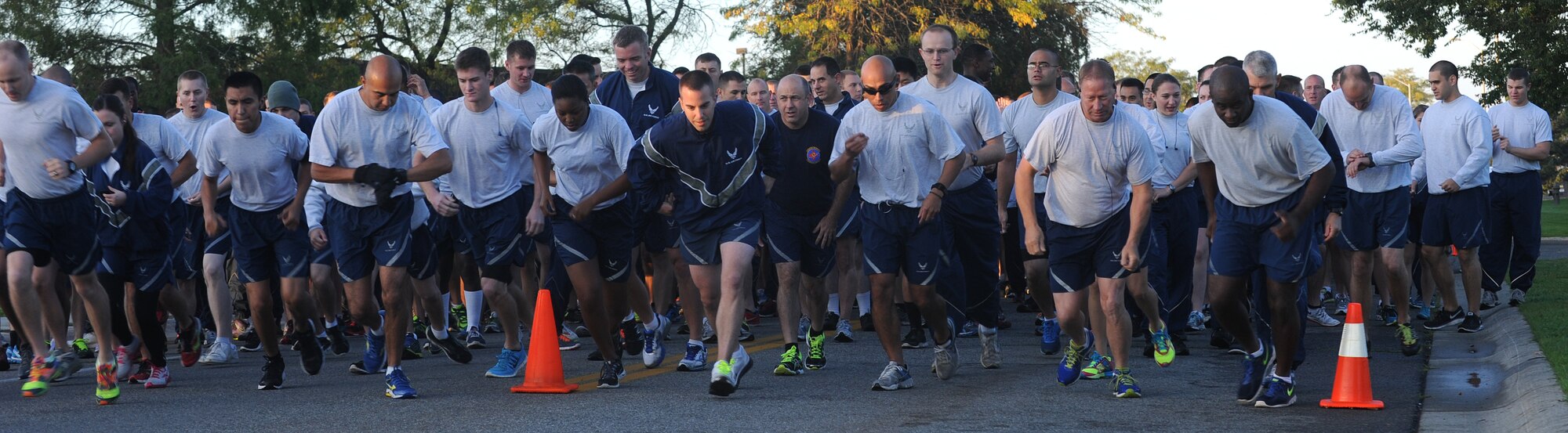Members of Team Fairchild take off from the starting line during the last wing run of the year at Fairchild Air Force Base, Washington, Sept. 26, 2014. The run covers about 1.5 miles around base, starting and ending at Miller Park. (U.S. Air Force photo by Staff Sgt. Samantha Krolikowski/Released)