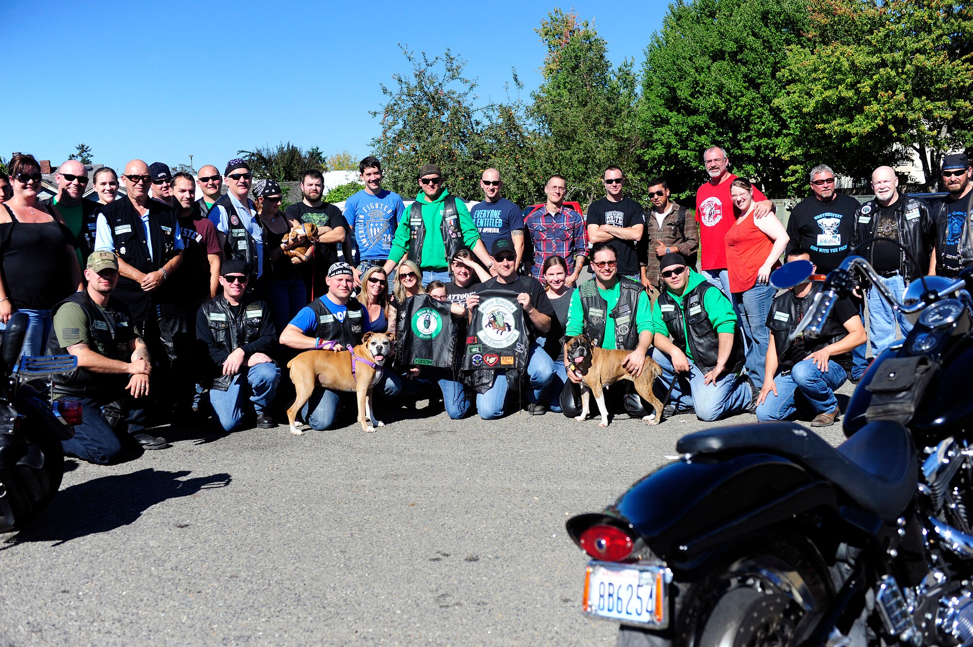 Members of the Green Knights Military Motorcycle Club and the Northwest Boxer Rescue come together for a photo after $1,500 was raised for the NWBR Sept. 20, 2014, in Eatonville, Wash. The NWBR’s boxers are rescued from inhabitable living situations and families unwilling to care for them. (U. S. Air Force photo/Senior Airman Rebecca Blossom)