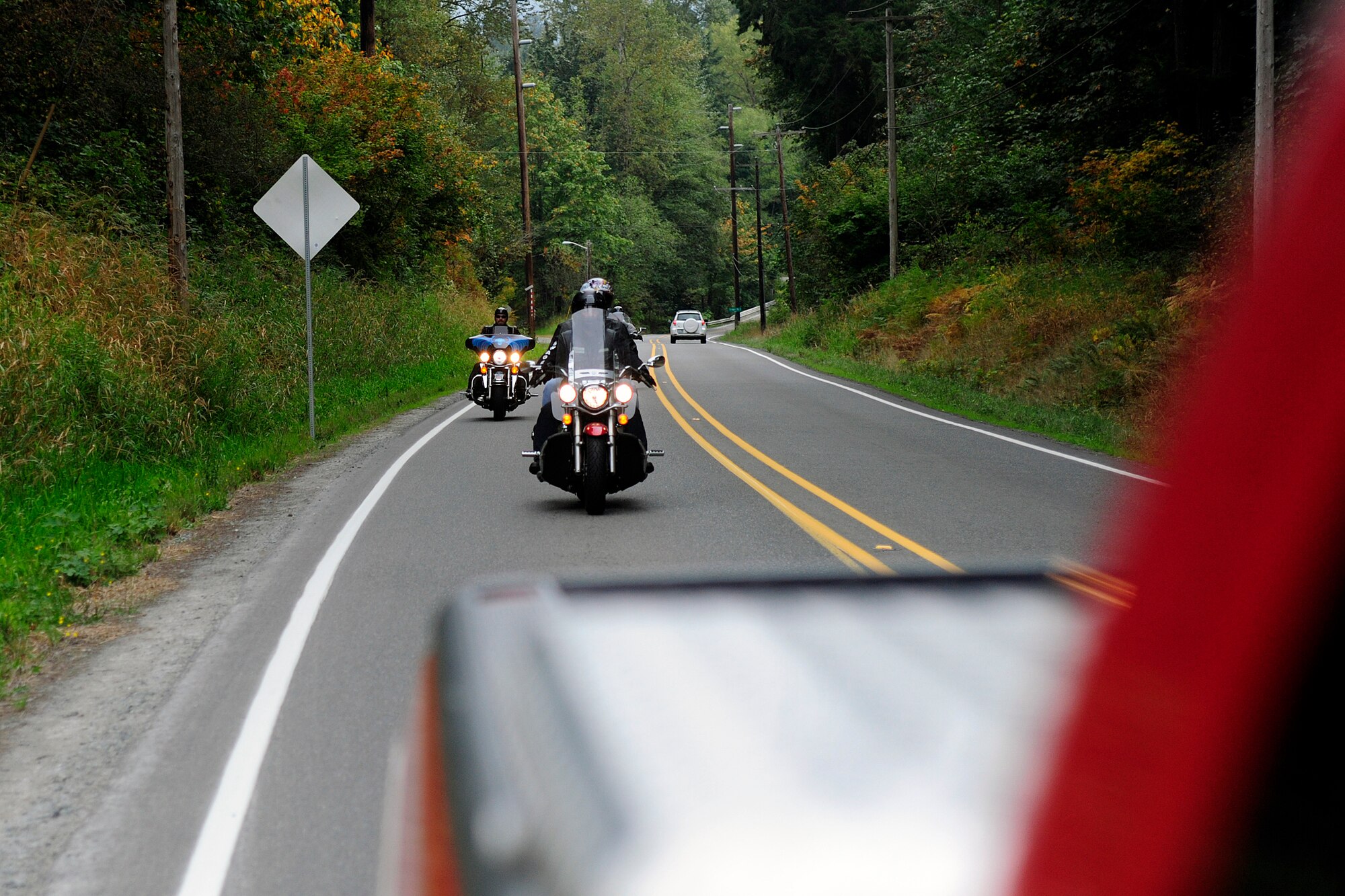 Tech. Sgt. Kevin Isaac Beers, 446th Security Forces Squadron combat arms instructor, leads fellow Green Knights Military Motorcycle Club members toward one of five destinations of the Northwest Boxer Rescue Poker Run Sept. 20, 2014, in Tacoma, Wash. The motorcyclist rode more than 90 miles, encompassing scenic areas of Tacoma and Mount Rainier. (U. S. Air Force photo/Senior Airman Rebecca Blossom)