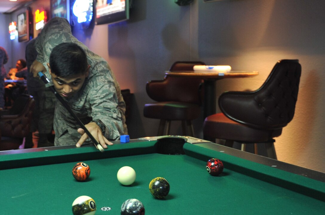 Airman 1st Class James Morales, 82nd Medical Group mental health technician, lines up a billiards shot following an enlisted all call Sept. 25, 2014, at the Sheppard Club’s Back Shop. The club’s newly redesigned features provide permanent party Airmen to kick back and enjoy the Sheppard Club. (U.S. Air Force photo/Airman 1st Class Robert L. McIlrath)
