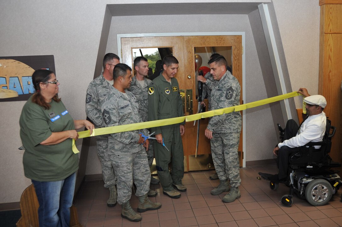 Base leadership participates in a ribbon cutting ceremony to symbolize the opening of the Sheppard Club’s Hangar One, Sept. 25, 2014, at Sheppard Air Force Base, Texas. Hangar one is the newly redesigned hangout for permanent party Airmen. (U.S. Air Force photo/Airman 1st Class Robert L. McIlrath)
